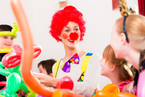 Clown at children birthday party entertaining the kids